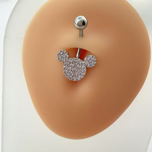 Sparkling mouse ear CZ pave curved belly button ring displayed on a realistic silicone navel model for body piercing jewelry styling.