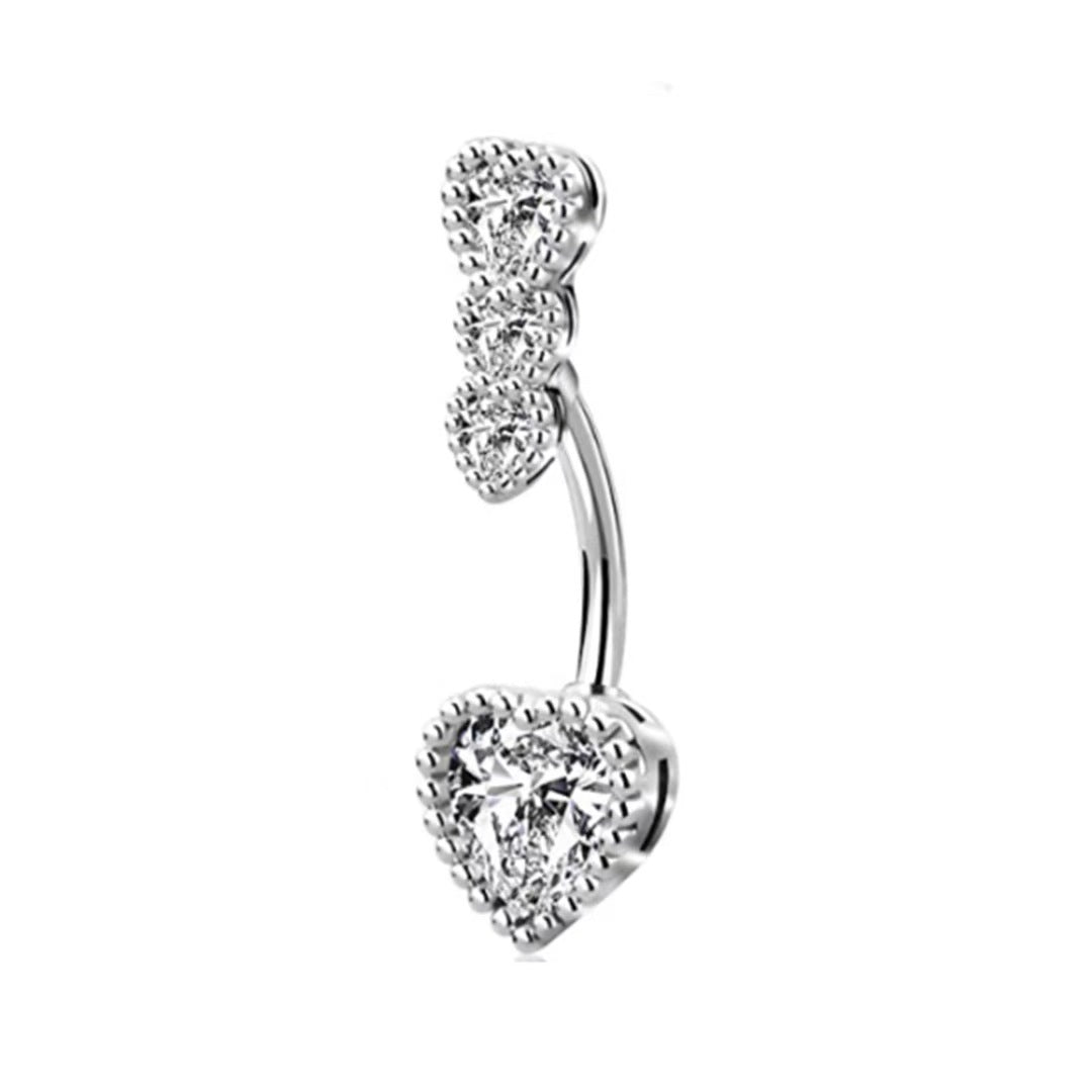 A silver curved barbell belly button ring featuring a vertical row of three mini rhinestone hearts and a large crystal-encrusted heart charm.