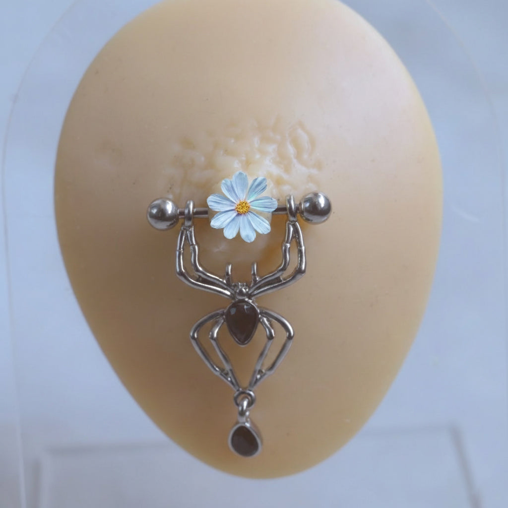 Gothic spider nipple shield jewelry worn on a silicone display model to show fit and aesthetic.