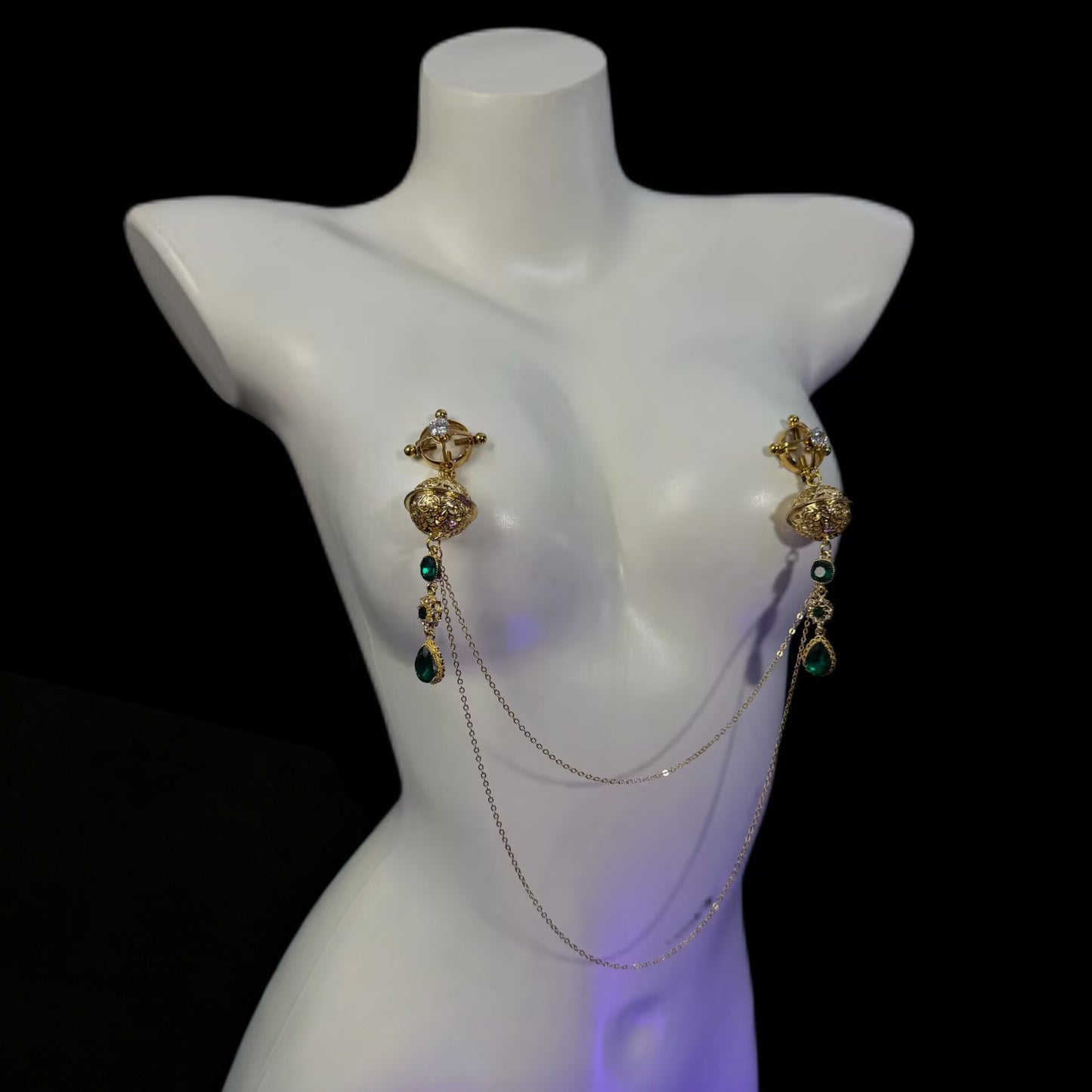 Adjustable spiral screw hoop nipple clamps with crystal accents, emerald pendants, and connecting gold chains.