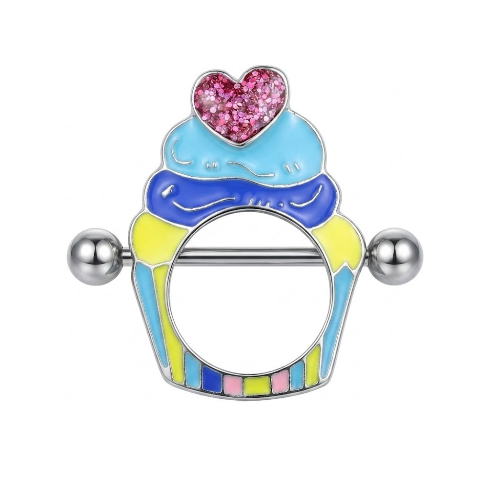 Front view of a 14G cupcake nipple shield ring piercing featuring colorful blue and yellow enamel design with a pink glitter heart on a pure white background.