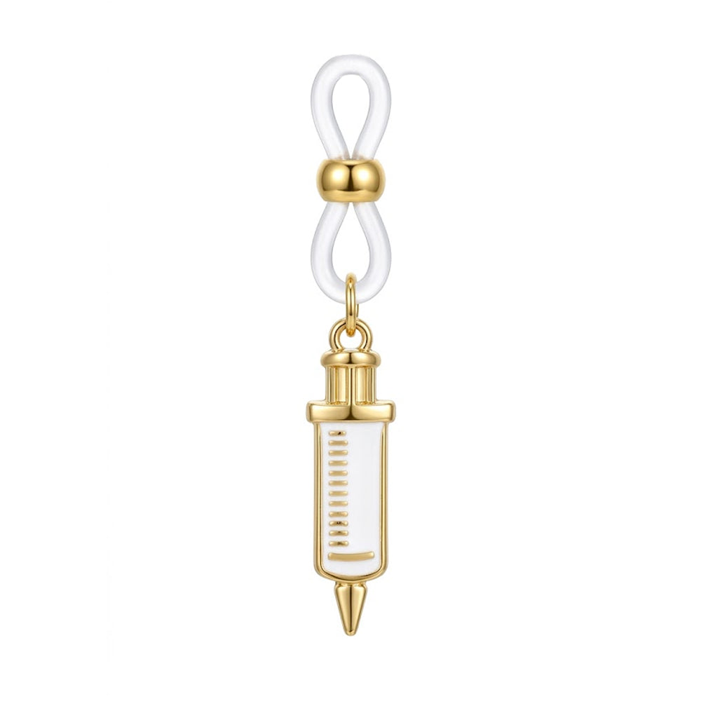 A single gold-plated syringe dangle non-pierced nipple clamp featuring a white enamel charm with measurement lines and an adjustable clear silicone loop, shot on a pure white background.