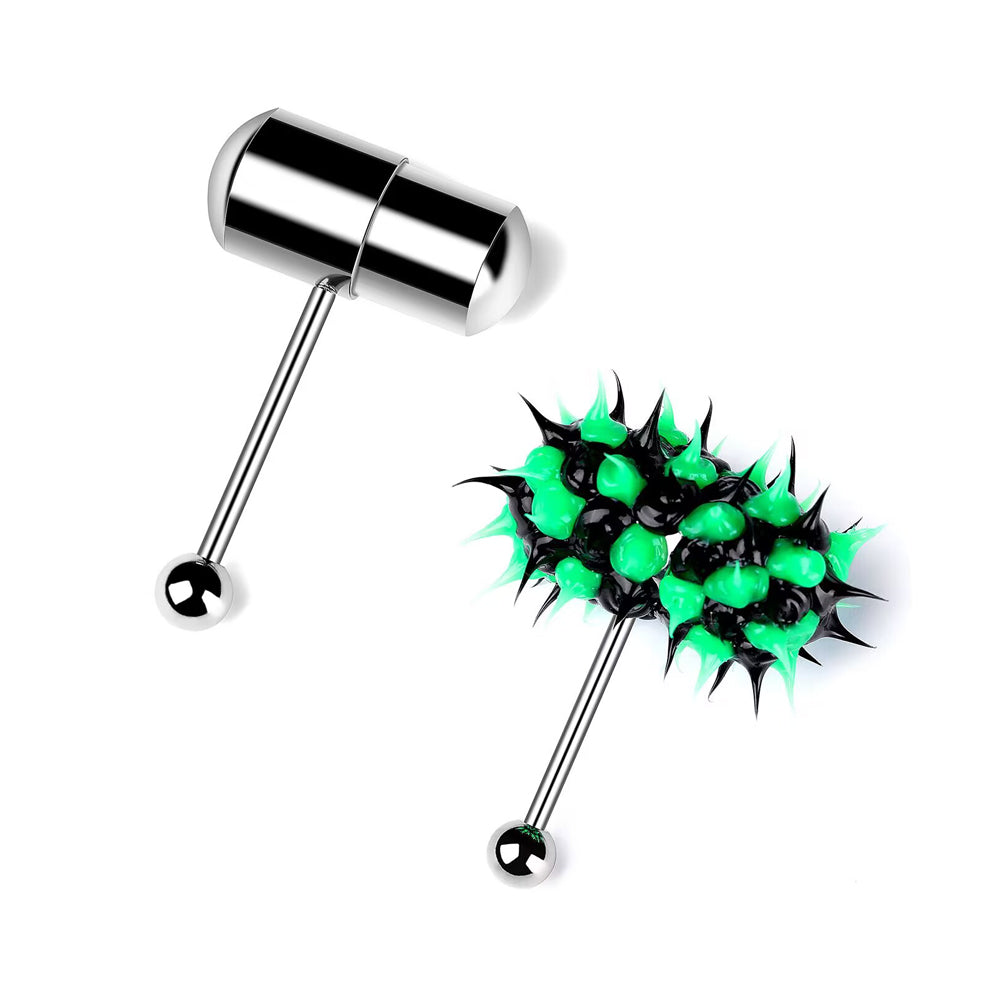 A white background comparison shot of two vibrating tongue piercing barbells. One features a sleek silver stainless steel pill-shaped capsule top, and the other features a black and lime green soft silicone spiked ball top. Both have surgical steel bars and bottom balls, shown at an angle.
