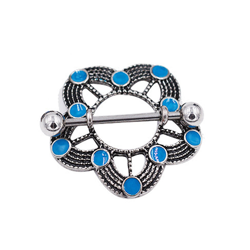 An antique silver style nipple shield featuring a circular floral design with bright blue circular accents on a white background.