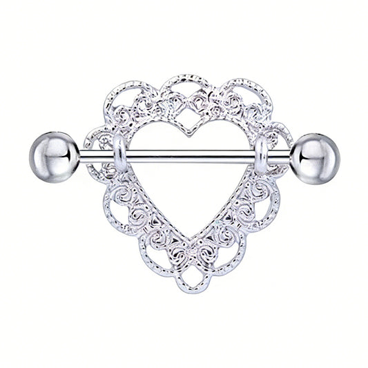 Close-up of a silver heart-shaped nipple shield with intricate lace filigree patterns and a straight barbell.