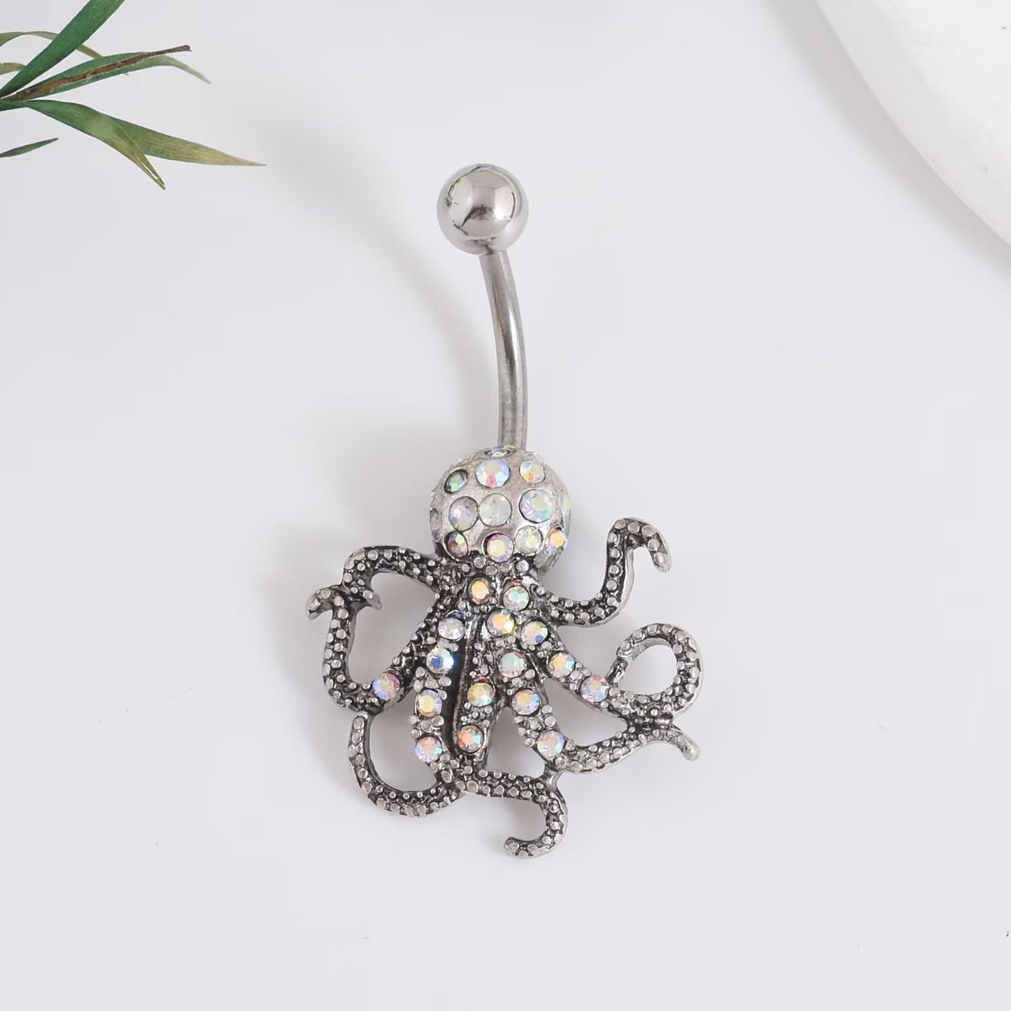 A vintage antique silver octopus belly bar encrusted with iridescent aurora borealis crystal stones.