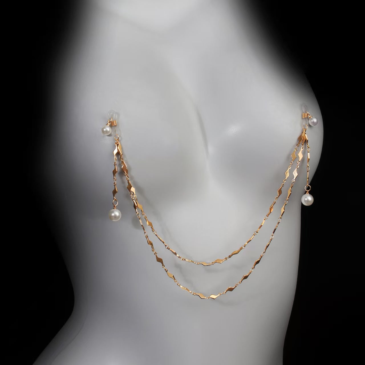 Side view of a layered gold body chain with pearl pendants beautifully draped on a mannequin chest, representing vintage romantic alternative fashion.
