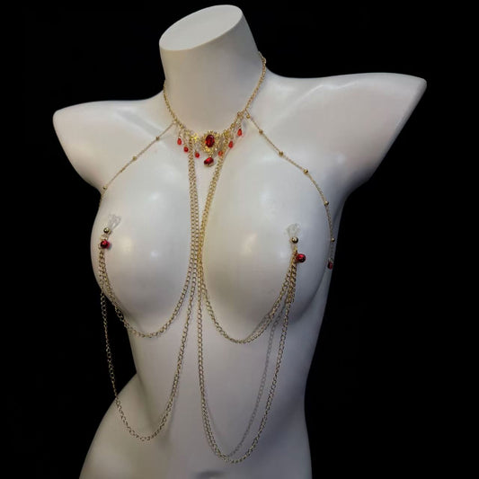 Close up of a vintage ruby choker and cascading gold chains with non-pierced invisible silicone loops.