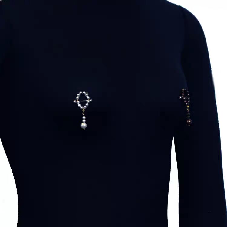On-model view of an elegant white pearl dangle nipple ring with drop pendant.