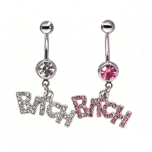 A pair of silver Y2K curved belly button rings with dangling Bitch word charms encrusted in pink and clear crystals on a white background.