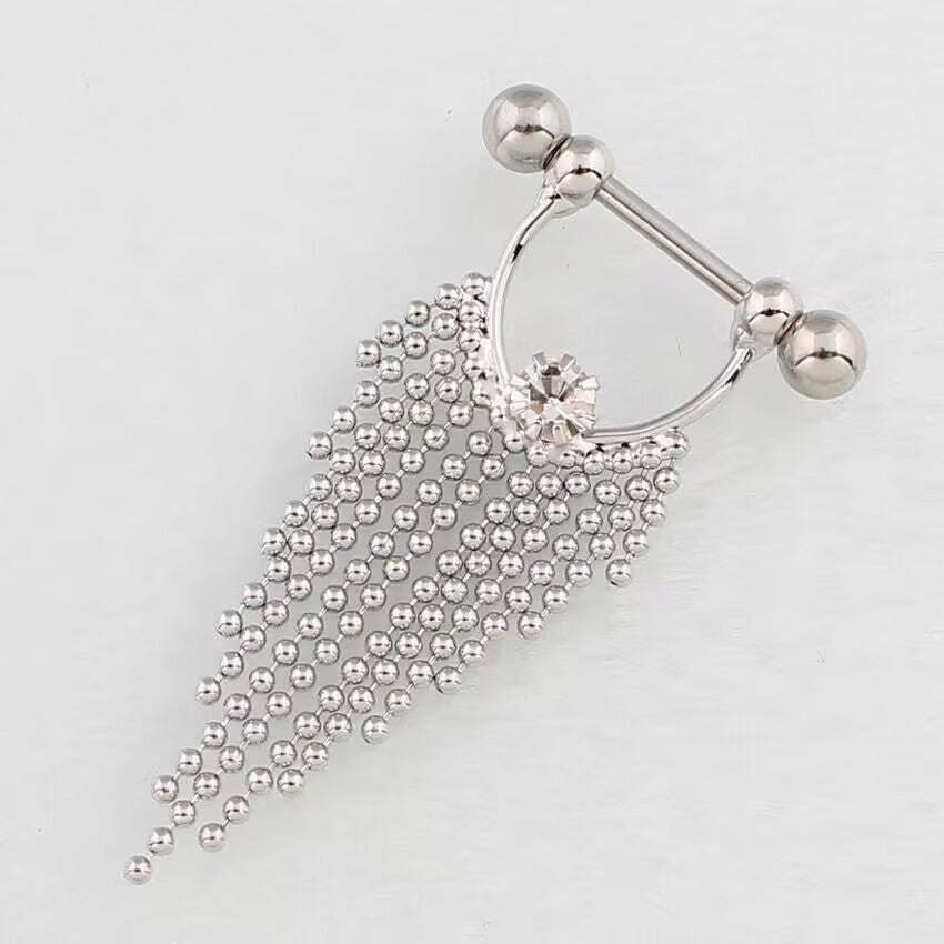 Close-up angled view of a Y2K style silver nipple barbell shield showing the sparkle of the central crystal and detailed beadwork.