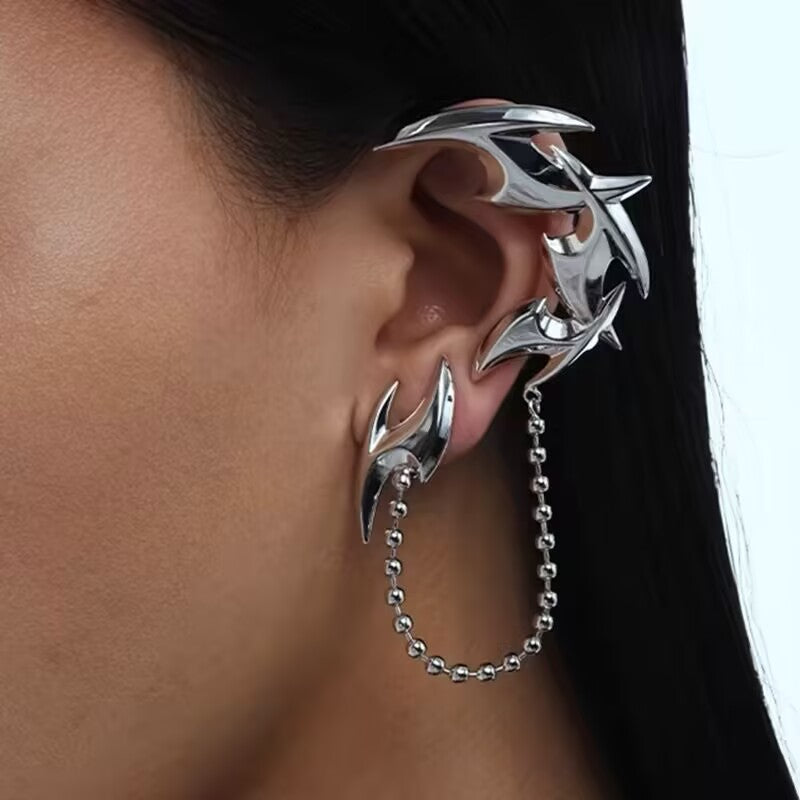 Y2K liquid metal flame ear cuff with ball chain worn on side ear in silver cyber goth style