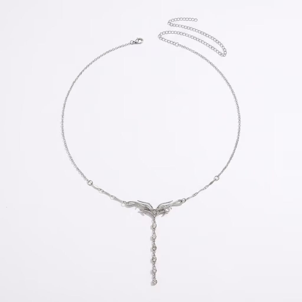 Flat lay view of Y2K silver liquid metal waist chain with extension chain on a clean white background