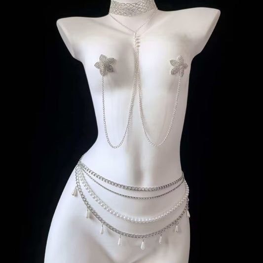 Silver Y2K star non piercing nipple chain connected to a multi layer pearl belly chain with teardrop pearls on a white mannequin torso, showing full body jewelry set styling.