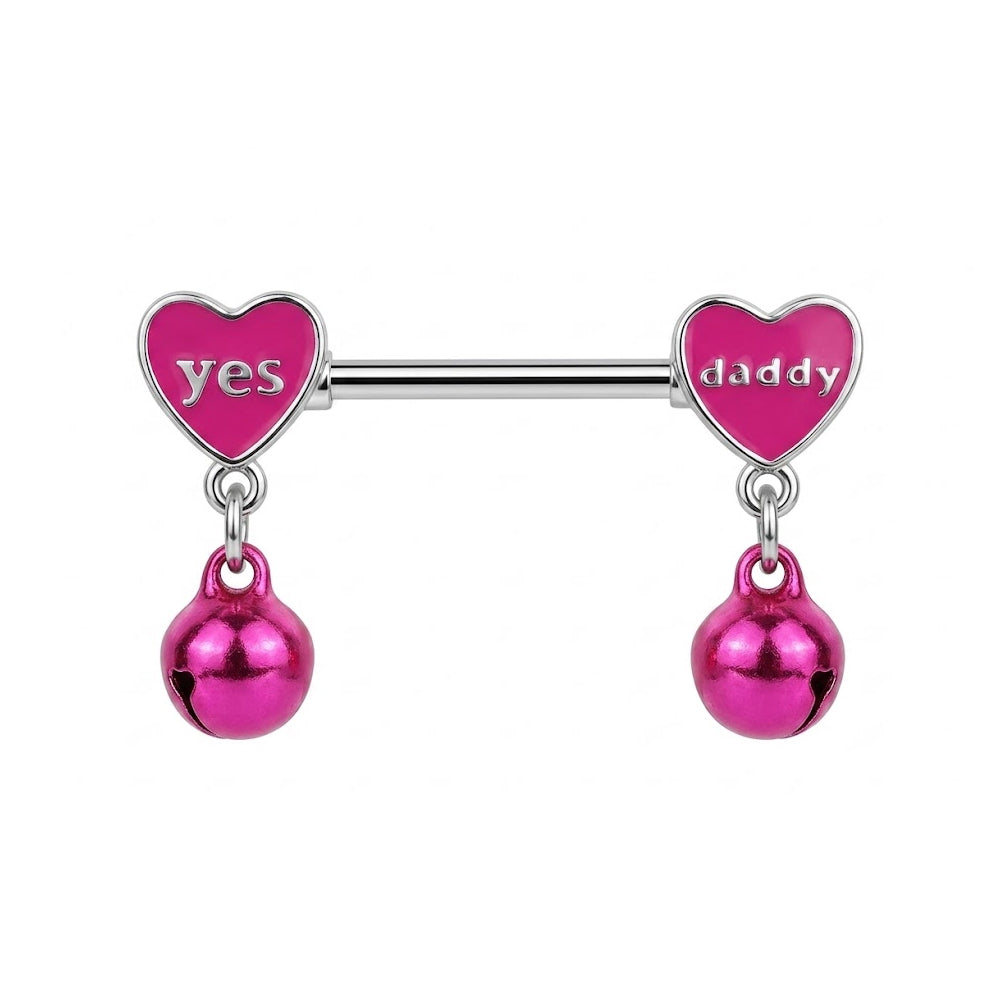 Close up of a silver nipple barbell featuring pink hearts with "Yes Daddy" text and hanging pink bells on a white background.