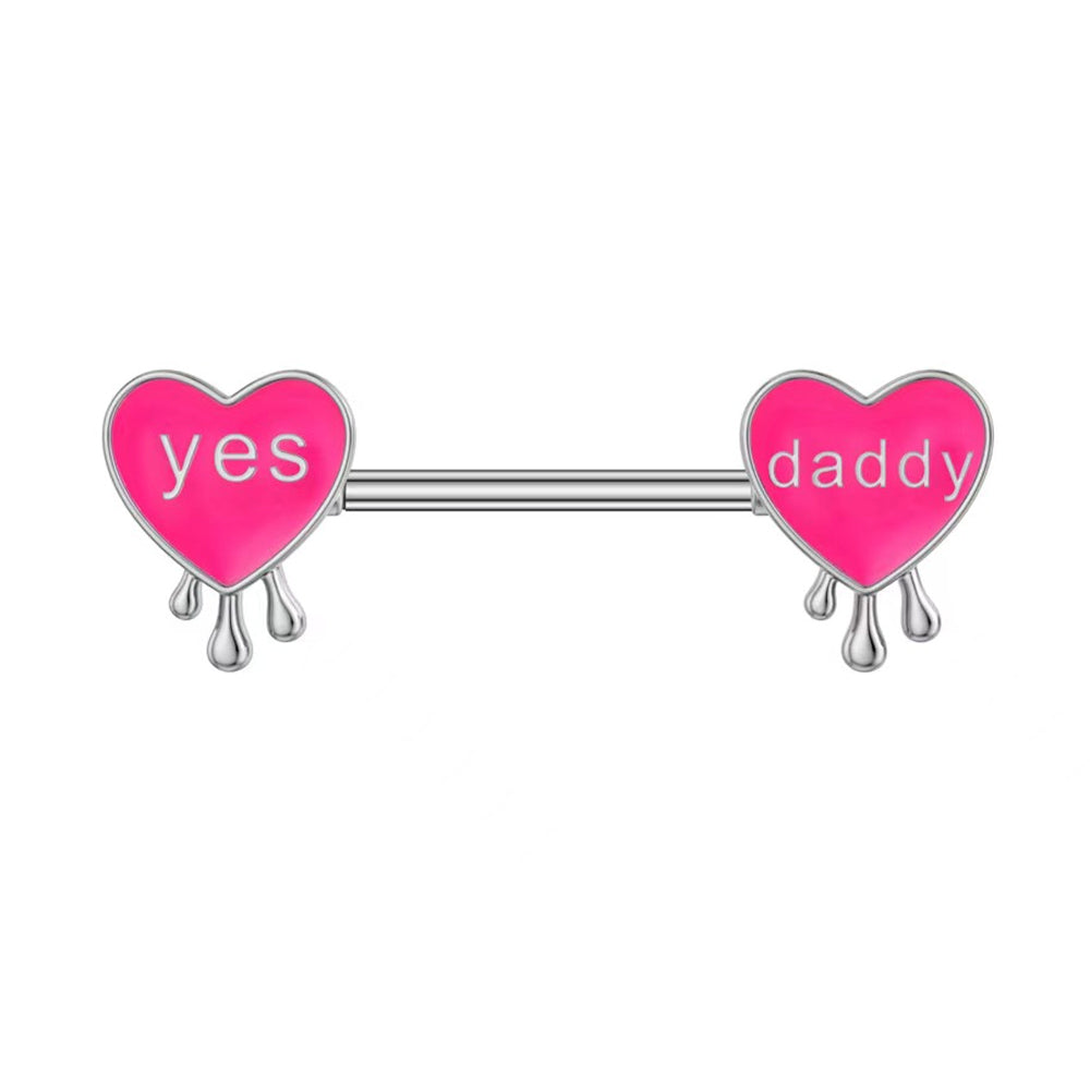Front view of pink heart nipple barbell with silver drip and "Yes Daddy" text.